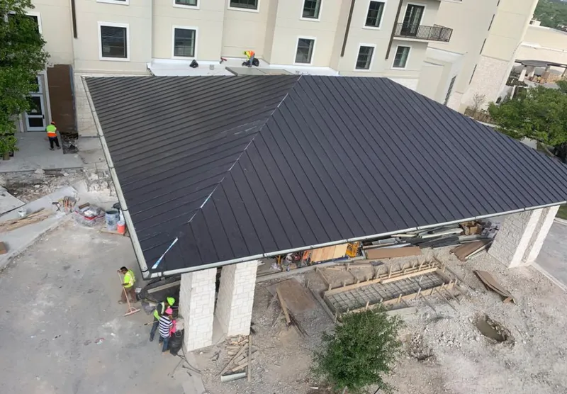 Metal roofing installation team working on a commercial building in Charles Town