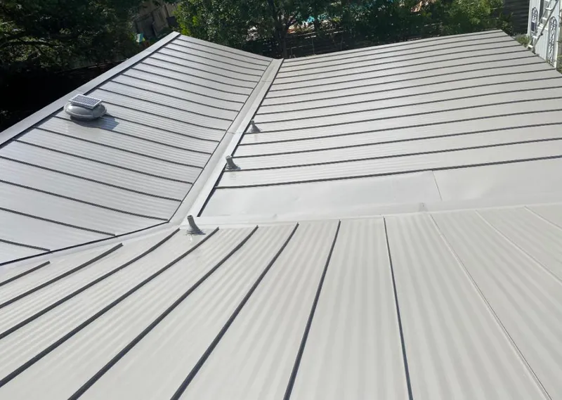 Solar attic fan installed on a metal roof for Roof Ventilation in Charles Town